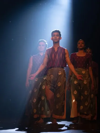 A dramatic spotlight on our performers during the 'Rasadrishta' show. We use professional lighting to create unforgettable stage visuals.
