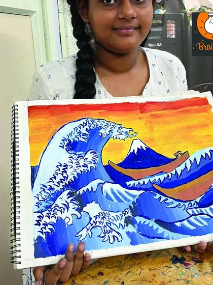 A student proudly displays her recreation of Hokusai's "The Great Wave." This master study taught her about line work, color blocking, and creating a sense of movement.