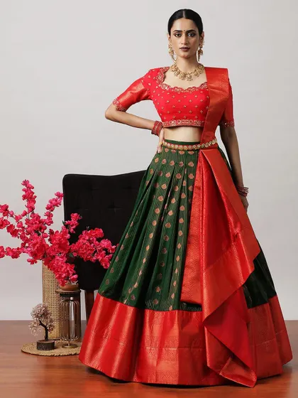 A beautiful green and red half-saree lehenga, featuring a brocade skirt and a rich red Banarasi border and dupatta.