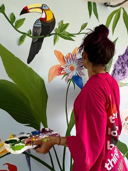 Here's a behind-the-scenes look at me working on the large tropical mural. It took about a week to complete, carefully painting each bird and leaf to bring the client's vision to life.