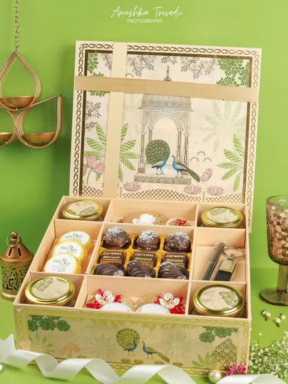 A grand, multi-layered Diwali hamper showcasing a wide assortment of sweets, cookies, and chocolates in ornate packaging.