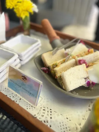 Mini vegetable sandwiches, a classic high-tea offering. We make them with fresh bread and a creamy vegetable filling, perfect for corporate events, baby showers, or afternoon parties.