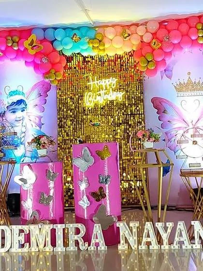 This grand butterfly setup uses a mix of bright colors and a shimmering gold backdrop to create a vibrant and exciting atmosphere.