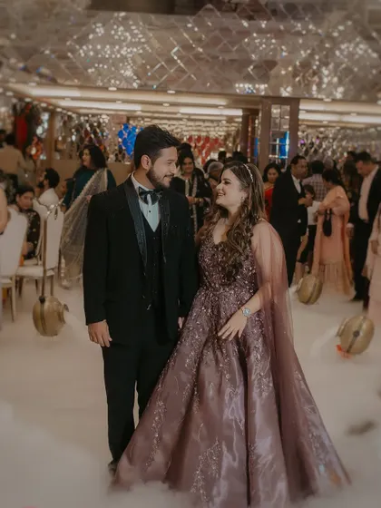 The grand entrance at an engagement party. This shot captures the couple looking happy and in love as they walk through a cloud of low fog.