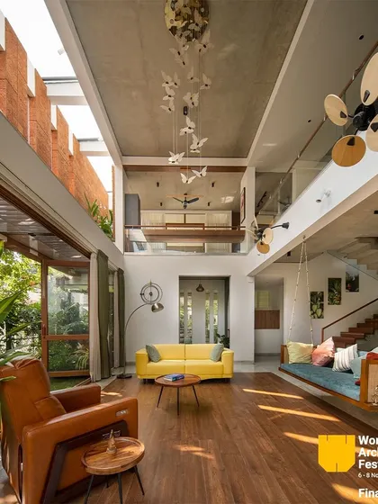 A wide shot of the living area, emphasizing its spaciousness and the seamless transition to the outdoor garden.
