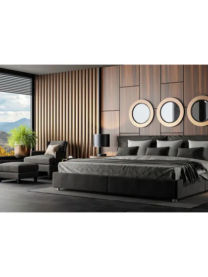 A modern bedroom with a dark, moody aesthetic. The wood-paneled accent wall, low-profile bed, and large window with a view create a space that feels both luxurious and connected to nature.