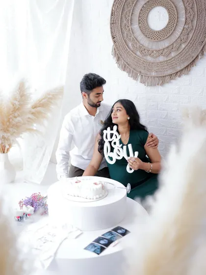 "It's a Boy!" This couple shares their exciting news with a sign, their happy expressions telling the rest of the story.