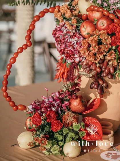 A centerpiece from the tropical event, featuring a heart-shaped garland and custom pet-themed coasters.