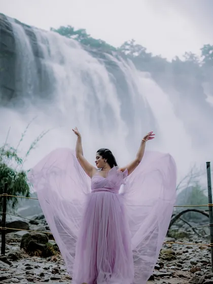 This is the magic I want for your pre-wedding shoot. Imagine yourself in this breathtaking lavender gown, with the tulle fabric catching the breeze against a stunning natural backdrop like this waterfall. It’s all about creating those epic, cinematic moments you'll cherish forever.