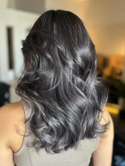 The back view of the Ash Lilac color. The waves showcase the dimension and the beautiful, seamless blend of tones.