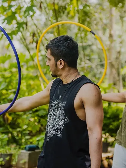Here I am giving some pointers during a hoop workshop. I work with each person to help them get comfortable with the prop, whether it's learning a new trick or just getting the hoop to spin.