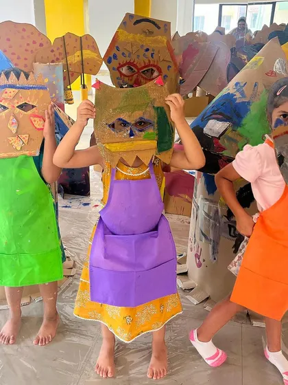 Children proudly holding up the imaginative masks they created during one of our art jams. This activity encourages them to explore identity and character creation through hands-on crafting.