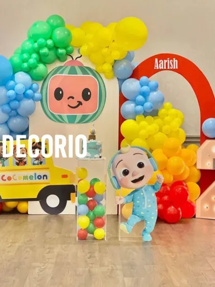A bright and cheerful Cocomelon theme party, one of my most popular requests for toddlers. This setup includes character cutouts of JJ and the iconic yellow bus, a colorful balloon arch, and a Cocomelon-head backdrop, creating an immersive experience for the little ones.
