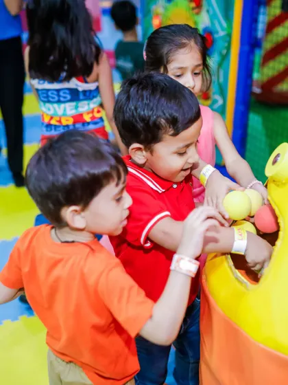 Teamwork makes the dream work! Kids collaborate to feed balls into one of our interactive play features during a fun-filled birthday bash.