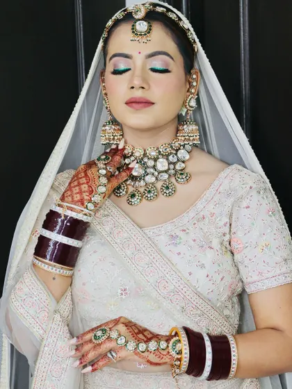 The complete look, with the bride's hands framing her face.