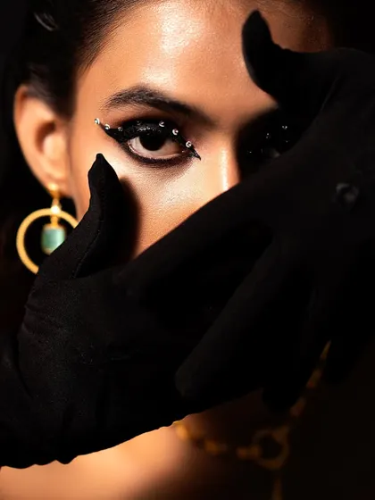 A "Jet Black Vibes" concept shoot I directed and styled. I used a black-on-black theme with a leather corset, turban, and dramatic, crystal-studded eye makeup to create a powerful and mysterious editorial look.