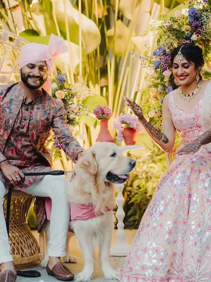 A happy couple and their furry friend enjoying the Mehendi celebration. We love incorporating pets into the special day.