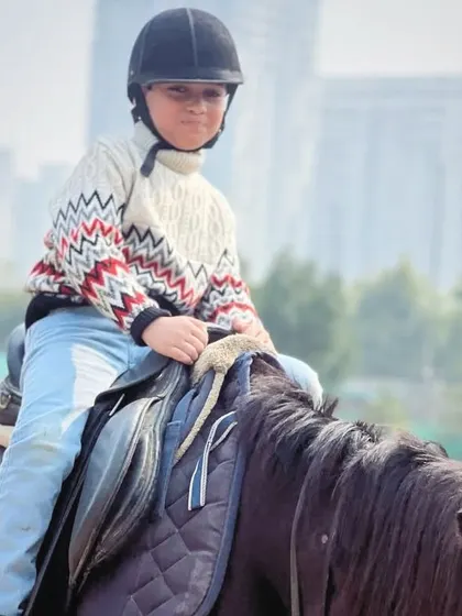 A young boy sits comfortably in the saddle during a winter ride. Horse riding is a year-round activity at our club.