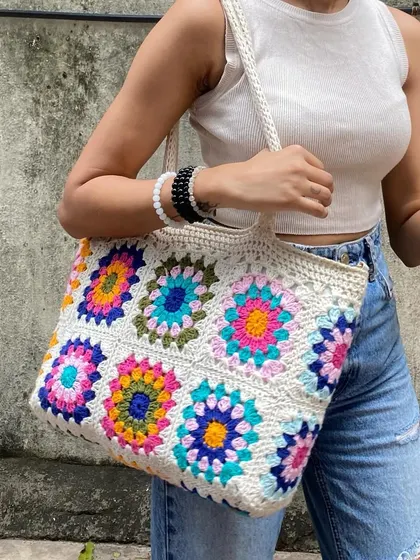 The sturdy crochet strap and roomy interior of our granny square tote make it both practical and beautiful. We use quality yarn to ensure it lasts.