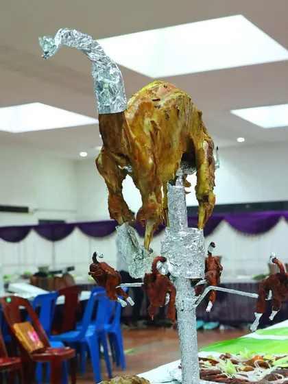 Another angle of our impressive Raja Virundhu setup, showcasing the whole roasted mutton on its custom stand before being served to the families.