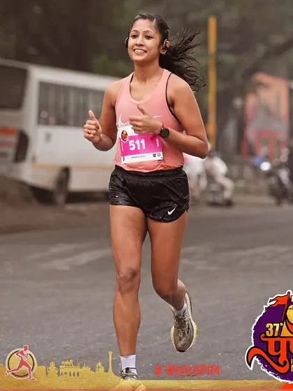 When you understand the game, you don't panic. A confident smile during the Pune International Marathon, knowing the training has prepared me for this.