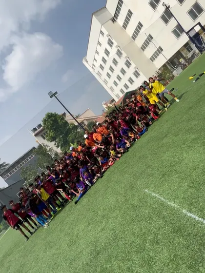 The whole squad together. A wide shot of our players and coaches on the field, a testament to the large and growing community at Playsmart.