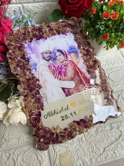 An angled shot showing the glossy, protective layer of resin over the photo and preserved flowers. This ensures the keepsake will last for years to come.