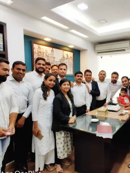 A group photo celebrating the success of a former intern. His journey is a testament to the hard work and dedication required in this profession.