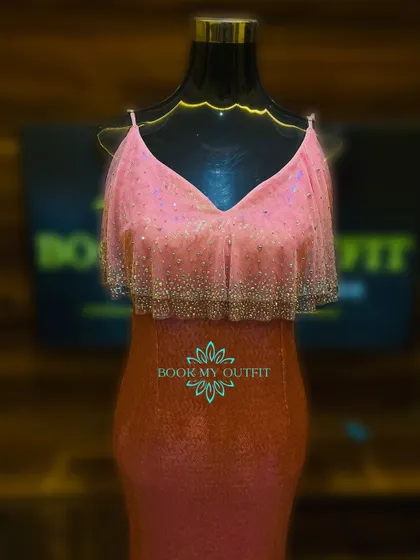 A close-up of the bodice on our ombre sequin gown, showing the delicate V-neckline and the sparkling fringe detail. This dress is perfect for cocktail parties and receptions.