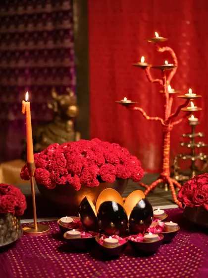 The complete 'Rang Saari' setup, blending bold reds, traditional brass, and ambient candlelight.