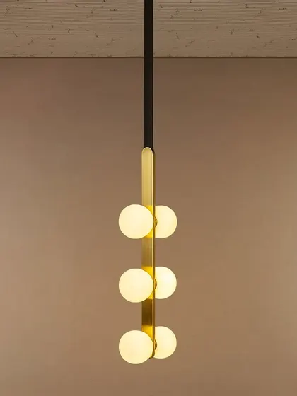 I love this pendant for its modern simplicity. The vertical arrangement of six opal globes on a sleek black and gold spine makes it a perfect lighting solution for stairwells, entryways, or rooms with high ceilings, providing a beautiful cascade of light.