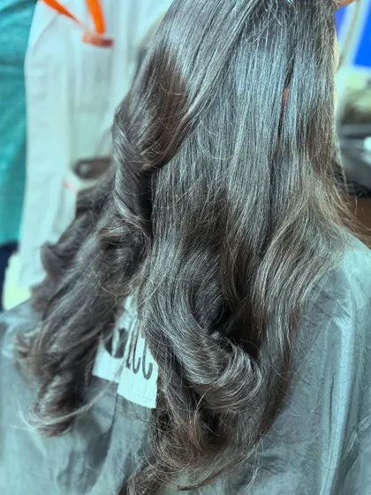 The back view of a classic top square layered haircut. This technique is essential for creating volume and movement in long hair.