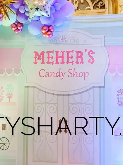 A personalized 'Meher's Candy Shop' sign, adding a custom touch to the main stage backdrop.