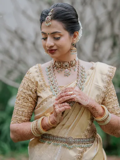 A three-quarter shot showing the intricate details of her jewellery and saree.