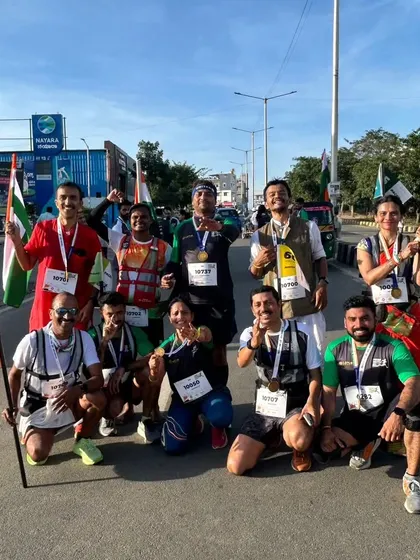 A group of proud runners with their medals and flags after conquering the challenging Freedom Run course.