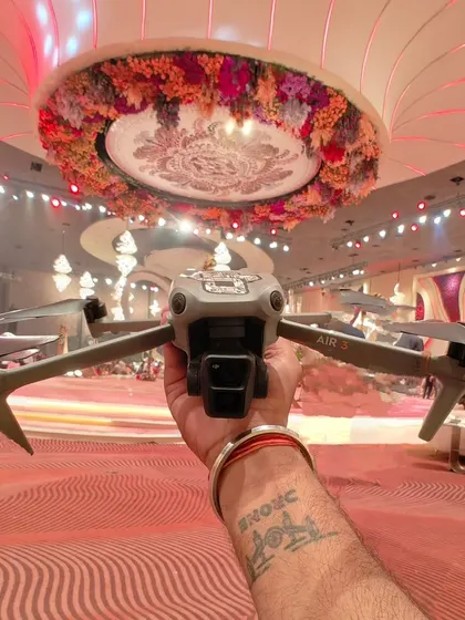 Getting my DJI Air 3 drone ready for an indoor shoot inside a lavishly decorated banquet hall. I am experienced in safely operating my drones in complex indoor environments to get you the perfect shot.