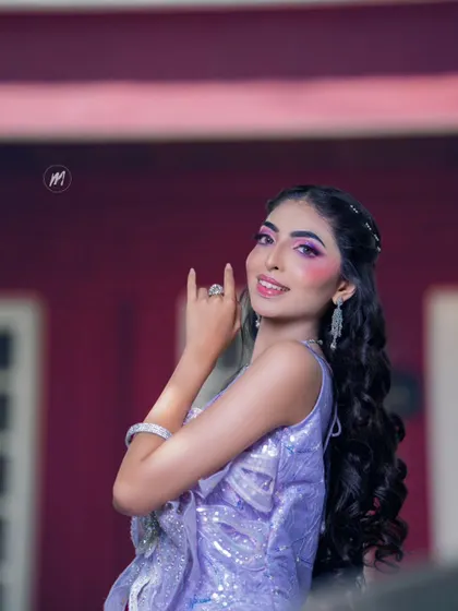 A model showcasing a stunning lavender sequined gown, perfect for a glamorous evening event. The diamond-look jewellery completes the look.