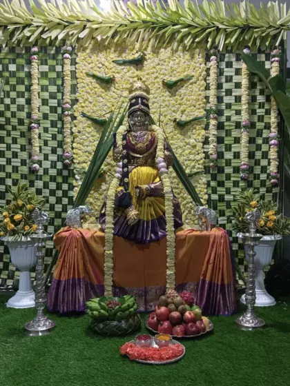 I specialize in decorations for religious festivals like Varamahalakshmi puja. This setup includes a backdrop of traditionally woven coconut leaves and a decorated mantap for the goddess.