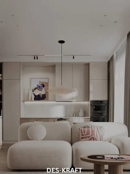 This living room showcases a curved, modular sofa and a mix of textures, creating a soft, inviting space that is both modern and comfortable.
