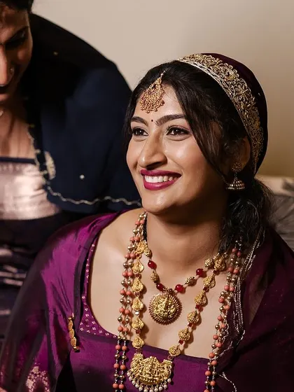 An intimate moment between the bride and a family member. Her makeup is soft and pretty, perfect for capturing these precious memories.
