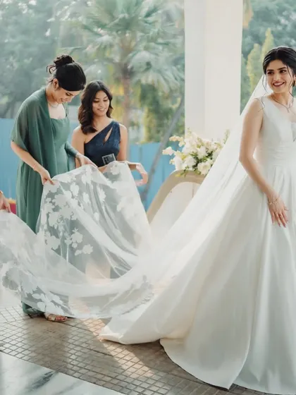 A princess moment with her bridesmaids. The flow of her classic A-line gown and long, embroidered veil is just breathtaking.