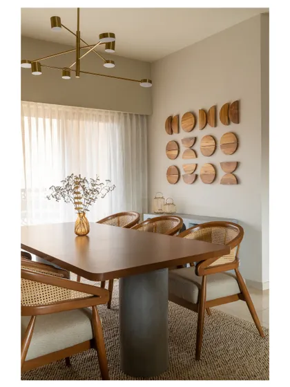 Another view of the dining room, showcasing a unique wooden wall art installation that adds a sculptural element to the space.