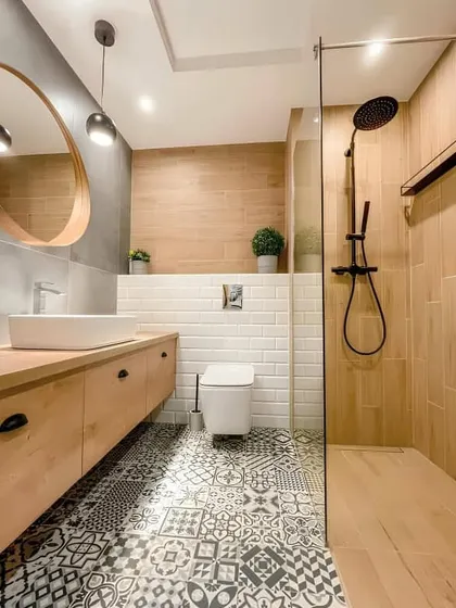 I used bold patterned floor tiles to add personality to this bathroom. The light wood floating vanity and white subway tiles on the wall keep the space feeling bright and clean.