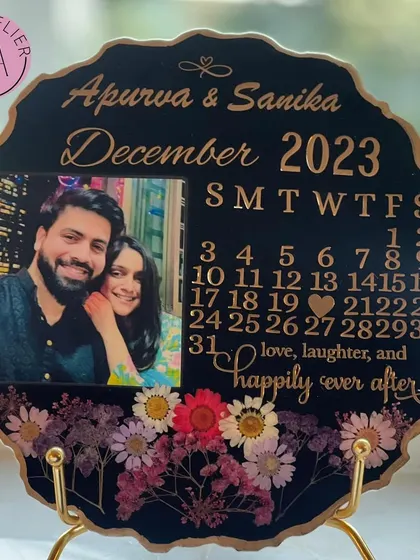 The finished black anniversary calendar displayed on a golden stand. It's a perfect piece of decor for a side table or mantelpiece, keeping a special memory in sight.