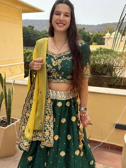 A happy client enjoying a destination wedding in my green and gold embroidered lehenga. It's lightweight, comfortable, and perfect for a daytime event.