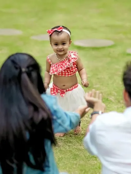 Those precious first steps. We captured this beautiful, unscripted moment as this little girl walks towards her parents' open arms during a relaxed outdoor family session.