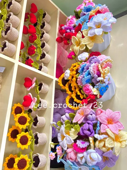 An angled shot of my shelves, showing how I organize different types of potted flowers and bouquets.
