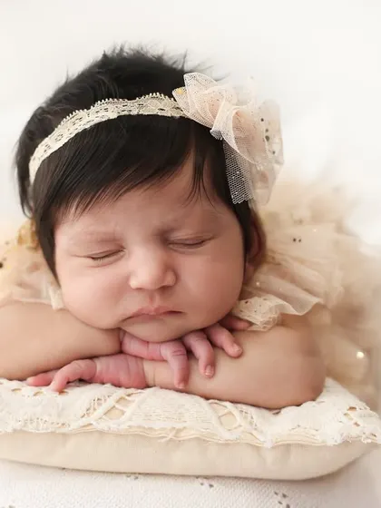 The quiet perfection of a newborn. I focus on capturing those tiny, delicate features, like the curve of their cheek and the peacefulness of their sleep. This classic head-on-hands pose is a timeless way to remember just how small they once were.