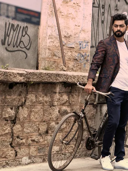 A wider shot from the bicycle series with Tarak Ponnappa, capturing more of the urban environment. This helps to set a scene and tell a story within the portrait.
