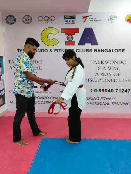 Tying a red belt.